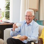 Senior engaging in healthy daily activities including gentle exercise, social interaction, balanced meals, and safe living habits to support overall wellness.