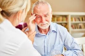 Concerned family member assisting elderly parent with memory tasks in a safe, organized home.