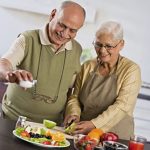Healthy balanced meal with water, fruits, vegetables, and protein supporting senior nutrition and hydration for fall prevention