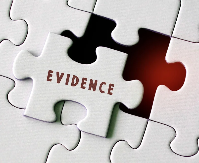 Puzzle with a piece labeled “evidence” symbolizing evidence-based fall prevention and comprehensive risk assessment