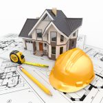 A 3D architectural model of a house sitting on top of blueprint floor plans, accompanied by a yellow construction hard hat, a yellow measuring tape, and a pencil, representing a traditional contractor's renovation focus.